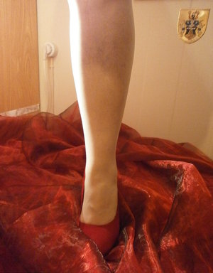 1 dark haired female tortures another during lezdom play in concrete cellar